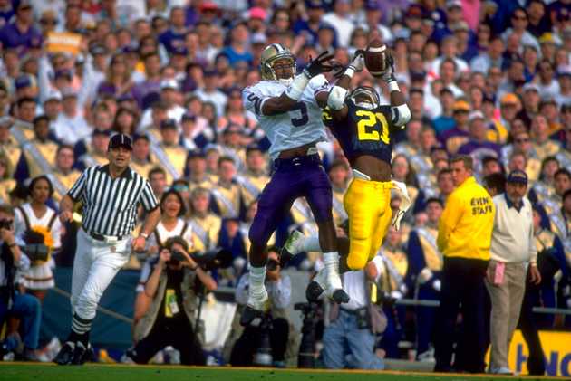 Michigan Desmond Howard (21) making catch vs. Washington Dana Hall (5).